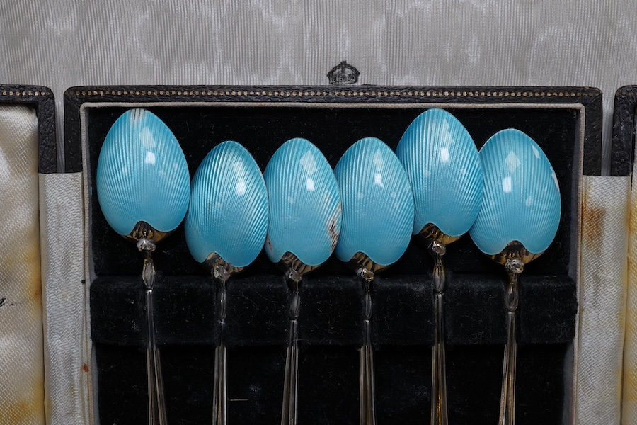 A cased set of German 800 standard white metal handled mother of pearl caviar knives, length 17cm, a cased set of six late 1950's silver and enamel coffee spoons, by Turner & Simpson (enamel a.f.) and a 19th century with